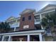 Close up of The Villas 100, building exterior with brick and covered parking at 1000 Ray Costin Way # 114, Murrells Inlet, SC 29576