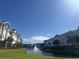 Beautiful condo community, showcasing waterfront views, lush landscaping, and a serene fountain at 1000 Ray Costin Way # 114, Murrells Inlet, SC 29576