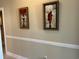 Neutral hallway featuring two pieces of art and trim at 1000 Ray Costin Way # 114, Murrells Inlet, SC 29576