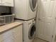 Convenient laundry area with a stacked washer and dryer and ample cabinet space at 1000 Ray Costin Way # 114, Murrells Inlet, SC 29576