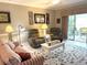 Cozy living room with sliders to a sunroom, coastal decor, and comfortable seating at 1000 Ray Costin Way # 114, Murrells Inlet, SC 29576
