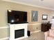 A living room with an electric fireplace and large TV, next to the dining area at 1000 Ray Costin Way # 114, Murrells Inlet, SC 29576