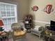 Cozy sitting area with a wicker chair, natural light, and fish decor at 1000 Ray Costin Way # 114, Murrells Inlet, SC 29576
