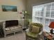 Inviting sitting area with wicker furniture, colorful accents, and natural light at 1000 Ray Costin Way # 114, Murrells Inlet, SC 29576