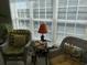 Bright sunroom with wicker furniture and ample natural light at 1000 Ray Costin Way # 114, Murrells Inlet, SC 29576