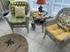 Bright sunroom with wicker furniture, cheerful cushions, and natural light at 1000 Ray Costin Way # 114, Murrells Inlet, SC 29576