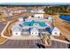 An aerial view of the community pool features a splash pad, hot tub, cabanas, lounge seating, and a sun-drenched patio at 1087 Baker Creek Loop, Myrtle Beach, SC 29579