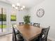 Inviting dining room features a stylish chandelier, wooden table, and access to the backyard at 1087 Baker Creek Loop, Myrtle Beach, SC 29579