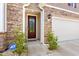 Charming front entrance with a stone facade, a stylish front door, and a security system at 1087 Baker Creek Loop, Myrtle Beach, SC 29579