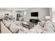 Bright living room featuring modern furniture, an entertainment center, and an open floorplan to the kitchen at 1087 Baker Creek Loop, Myrtle Beach, SC 29579