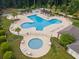 Aerial view of a large community pool with ample seating and shaded areas, perfect for outdoor enjoyment and relaxation at 1097 Stoney Falls Blvd., Myrtle Beach, SC 29579