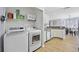 Functional laundry room with washer, dryer, and storage shelves at 1097 Stoney Falls Blvd., Myrtle Beach, SC 29579