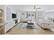 Open-concept living room with backyard access, ceiling fan, and modern furniture at 1097 Stoney Falls Blvd., Myrtle Beach, SC 29579