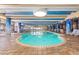 Indoor pool area with blue and white decor, tile flooring, and a view of the beach at 1105 South Ocean Blvd. # 806, Myrtle Beach, SC 29577