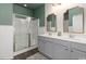Beautiful bathroom features double sink, white tiled wall, and glass enclosed shower at 112 Rialto Dr., Conway, SC 29526