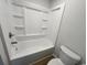 Bright bathroom features a tub and shower combination and built-in shelving at 116 Hickory Dr., Conway, SC 29526