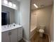 Bright bathroom features white cabinets, single sink vanity, and a shower-tub combo at 116 Hickory Dr., Conway, SC 29526