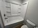 This bathroom has a shower-tub combo with molded shelves and a modern toilet at 116 Hickory Dr., Conway, SC 29526
