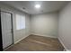 A bedroom with wood-look floors, a white door, and a window with blinds at 116 Hickory Dr., Conway, SC 29526