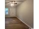 This cozy bedroom features wood-look flooring, a ceiling fan, and a double door closet at 116 Hickory Dr., Conway, SC 29526