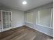 Sunlit bedroom featuring neutral walls, wood-look floors, and windows for lots of natural light at 116 Hickory Dr., Conway, SC 29526