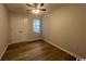 This cozy bedroom features wood-look flooring, a ceiling fan, and a double door closet at 116 Hickory Dr., Conway, SC 29526