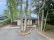 Home exterior showcasing beautiful landscaping, a paved driveway, and mature trees at 116 Hickory Dr., Conway, SC 29526