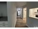 Hallway leads to a kitchen with stainless steel appliances and stone countertops at 116 Hickory Dr., Conway, SC 29526