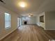 Bright living room features a fireplace, modern ceiling fan, wet bar, and sleek hardwood floors at 116 Hickory Dr., Conway, SC 29526