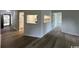 Open-concept living area with wood-look flooring throughout leading to kitchen at 116 Hickory Dr., Conway, SC 29526