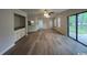 Bright living room features a wet bar, modern ceiling fan, and sleek hardwood floors leading to the exterior at 116 Hickory Dr., Conway, SC 29526