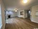 Bright living room features a fireplace, modern ceiling fan, wet bar, and sleek hardwood floors at 116 Hickory Dr., Conway, SC 29526