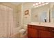 Bathroom featuring a combination tub and shower with cherry wood cabinets, providing both style and functionality at 1250 Camlet Ln., Little River, SC 29566