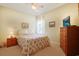 Comfortable bedroom featuring floral bedding and a light green wall, creating a warm and inviting space at 1250 Camlet Ln., Little River, SC 29566