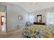 Inviting bedroom with soft blue walls, floral bedding, and a dresser with a mirror, creating a cozy atmosphere at 1250 Camlet Ln., Little River, SC 29566