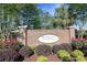 Well maintained entrance to Carolina Crossing community with brick sign, mature plants, and landscaping at 1250 Camlet Ln., Little River, SC 29566