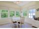 Bright dining area with a ceiling fan and several windows providing natural light and views of the outdoors at 1250 Camlet Ln., Little River, SC 29566