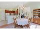 Open concept dining area featuring hardwood flooring with views into the kitchen and living room at 1250 Camlet Ln., Little River, SC 29566