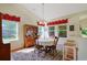 Cozy dining area with a round table, hardwood flooring, and lots of natural light from surrounding windows at 1250 Camlet Ln., Little River, SC 29566