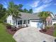 Charming home features a well-manicured yard with a concrete driveway and an attached two-car garage at 1250 Camlet Ln., Little River, SC 29566