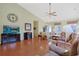 Comfortable living room features wood flooring, vaulted ceiling, ceiling fan, and a large screen TV at 1250 Camlet Ln., Little River, SC 29566