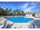 Large community swimming pool with ample seating and a bath house, surrounded by towering pine trees at 1250 Camlet Ln., Little River, SC 29566