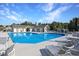 Community pool area with lounge chairs, shade umbrellas, and a pool house at 1250 Camlet Ln., Little River, SC 29566