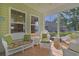 Relaxing sunroom with white wicker furniture, tile flooring, and many windows for ample natural light at 1250 Camlet Ln., Little River, SC 29566