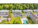 This aerial view shows the property with mature landscaping, a swimming pool, and ample parking at 1260 White Tree Ln. # F, Myrtle Beach, SC 29588