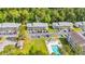 Aerial view of apartments with parking and a pool with lounge chairs surrounded by trees at 1260 White Tree Ln. # F, Myrtle Beach, SC 29588