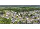 Aerial view of the community, showcasing its beautiful lake, lush landscaping, and well-maintained homes at 127 Willow Bay Dr., Murrells Inlet, SC 29576