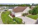 Aerial view of a tan home with a brown roof, surrounded by mature landscaping and a well-maintained lawn at 127 Willow Bay Dr., Murrells Inlet, SC 29576