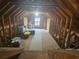 Spacious attic with exposed wooden beams and flooring, featuring natural light from a window at 127 Willow Bay Dr., Murrells Inlet, SC 29576