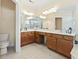 Large bathroom boasting a double vanity, ample countertop space, tiled floors, and a toilet at 127 Willow Bay Dr., Murrells Inlet, SC 29576